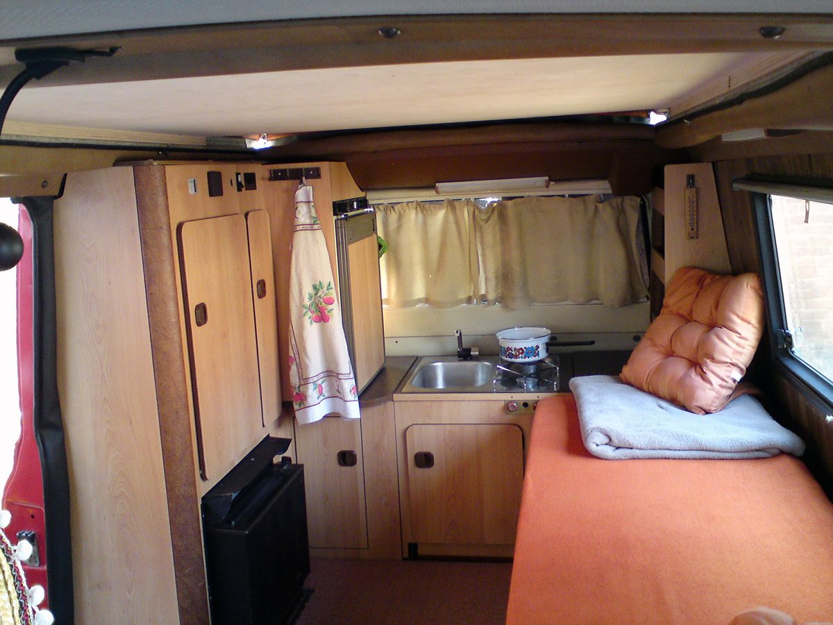 Interior of a camper van motorhome showing the living and cooking area