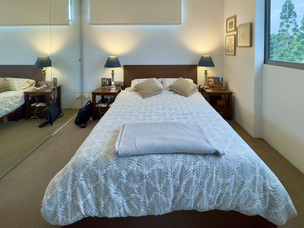 A tidy, well-made bedroom with clean surfaces to help keep fruit flies away