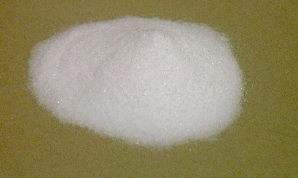 A pile of white baking soda (sodium bicarbonate), used to clean and deodorize drains