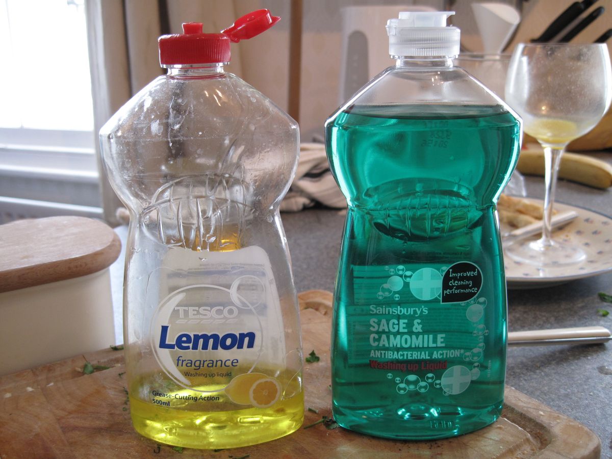 Two bottles of liquid dish soap; a few drops added to a water trap break the surface tension so fruit flies sink