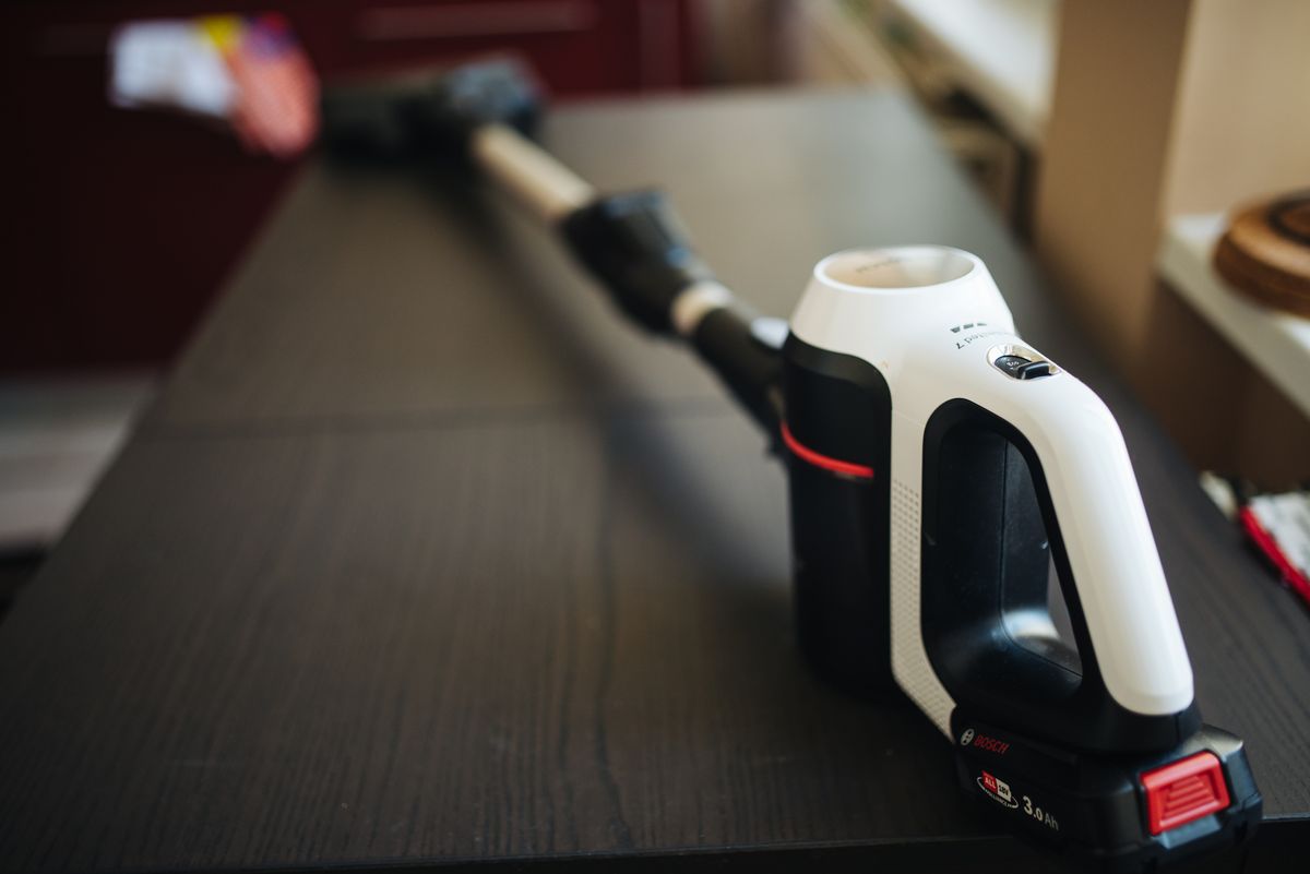 A modern cordless vacuum cleaner; its suction is a quick way to catch resting fruit flies off walls and surfaces