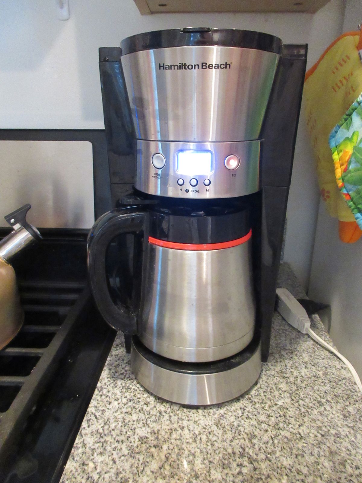 A drip coffee maker on a kitchen counter, where residue can attract fruit flies