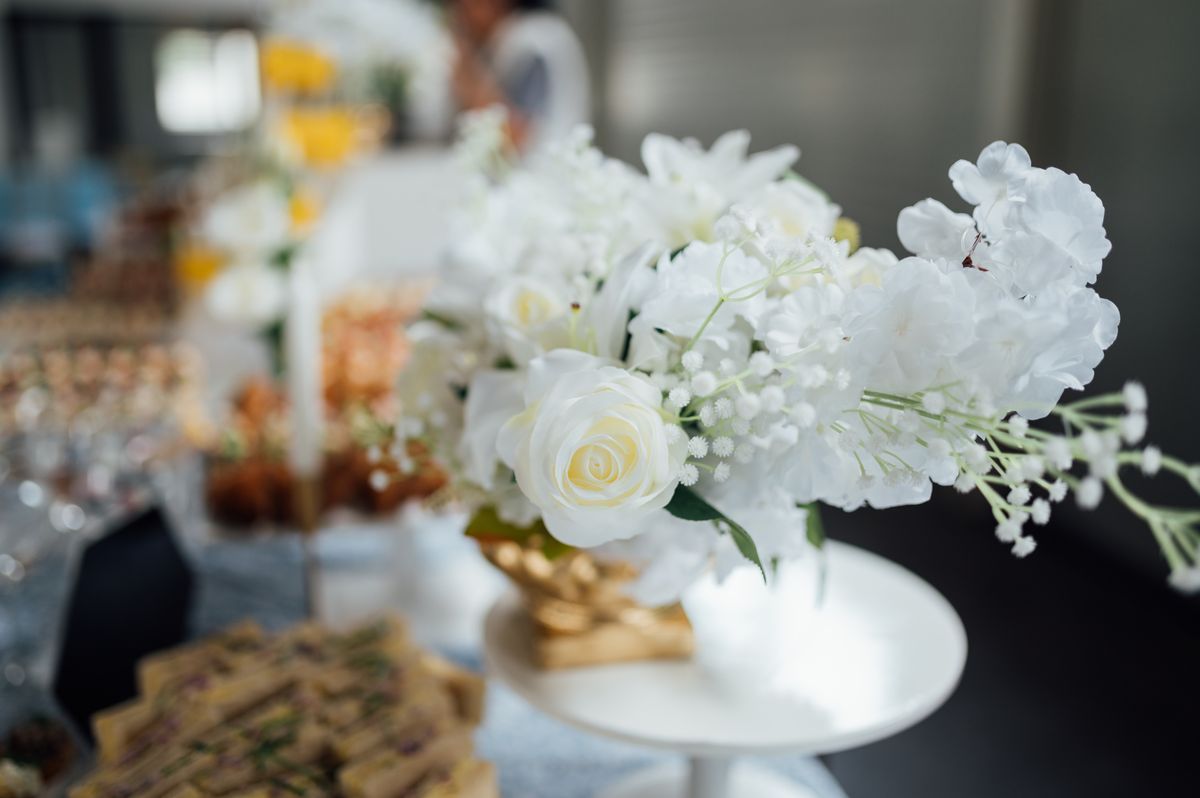 A bouquet of cut flowers in a vase on a table, whose sugary water can breed fruit flies