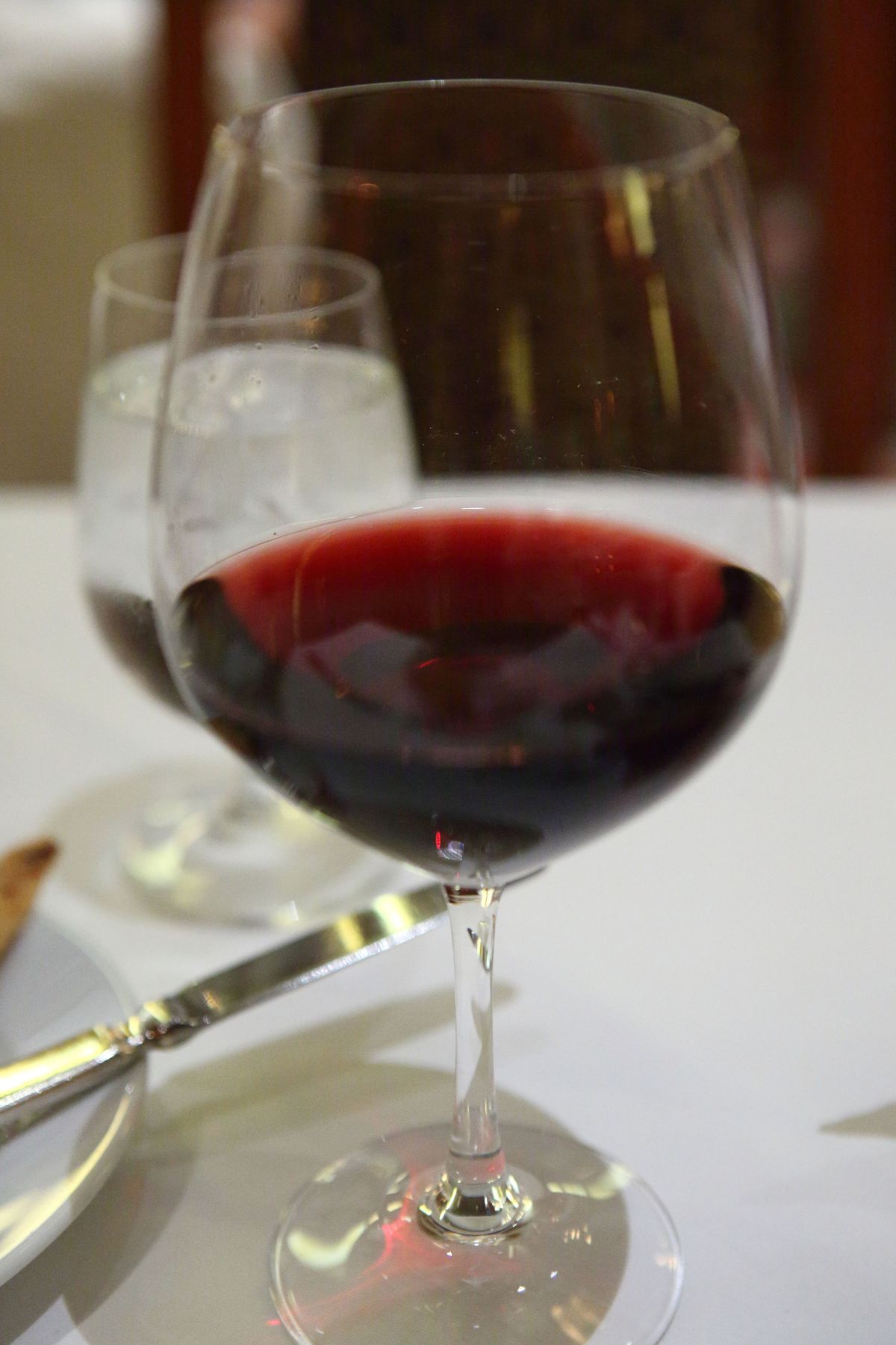 A glass of red wine, whose fermented aroma strongly attracts fruit flies