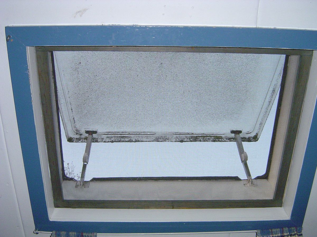 An open window fitted with an insect screen mesh, which helps keep fruit flies from entering