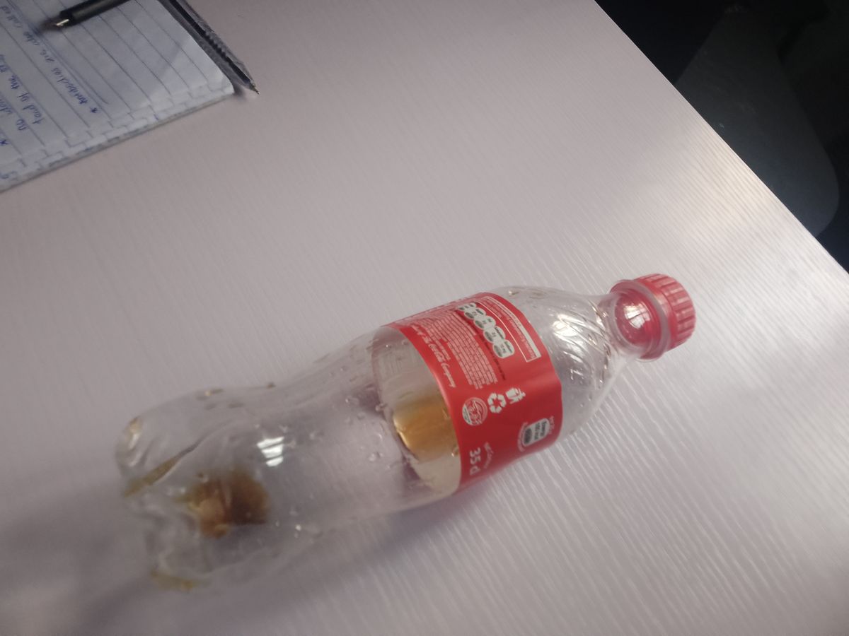 An empty clear plastic PET drink bottle, the base for a homemade funnel fruit fly trap